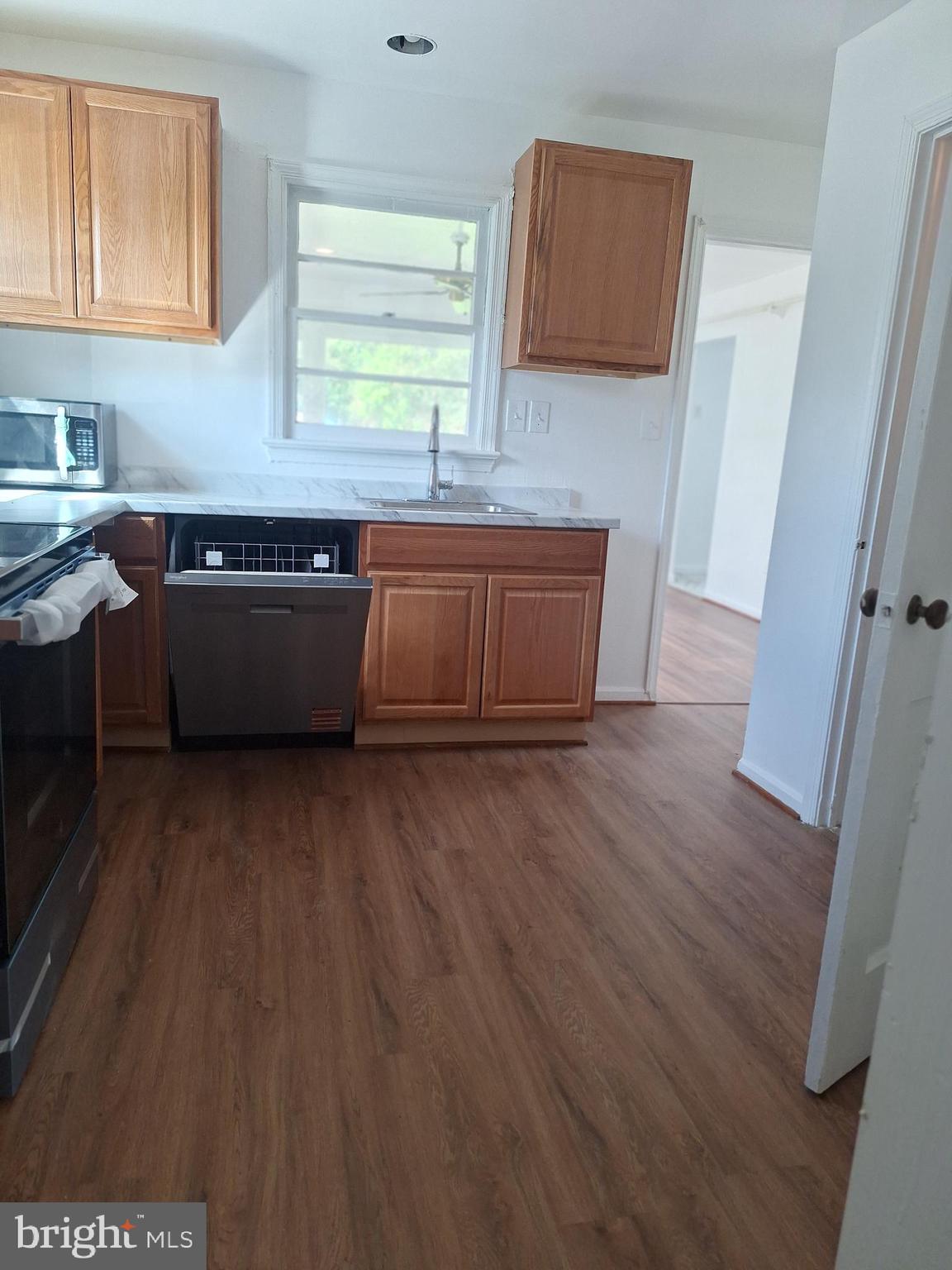 8816 Cooper Road Alexandria, VA 22309 - Photo 45 of 52 a room with wooden floor and window