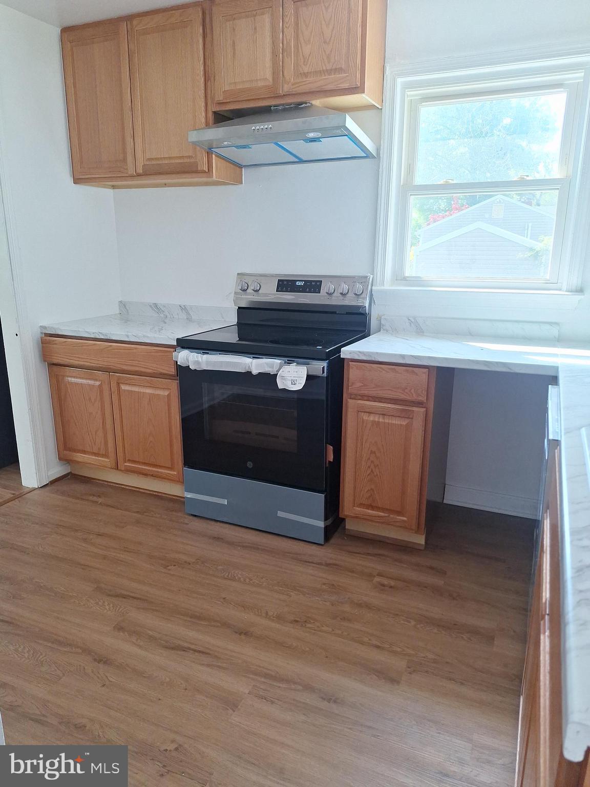 8816 Cooper Road Alexandria, VA 22309 - Photo 47 of 52 a kitchen with stainless steel appliances granite countertop a stove a sink and a microwave