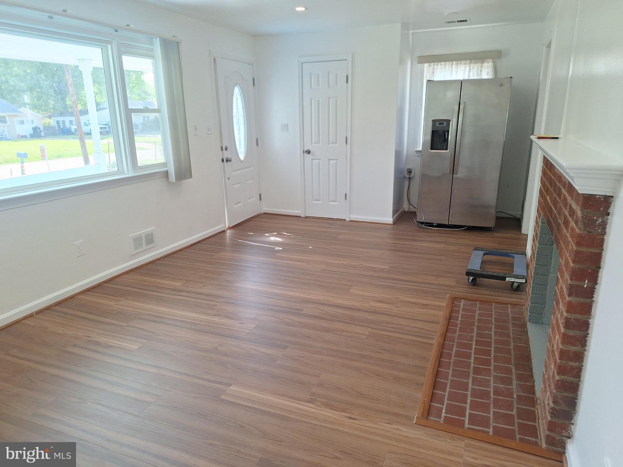 8816 Cooper Road Alexandria, VA 22309 - Photo 48 of 52 an empty room with wooden floor and windows