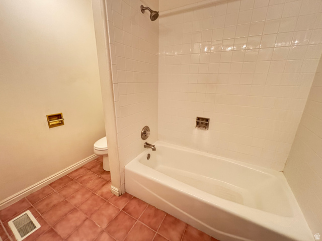 798 South 600 East Payson, UT 84651 - Photo 21 of 31 Bathroom featuring a white tub, shower with ceramic tile surround, and terra cotta floor tiles