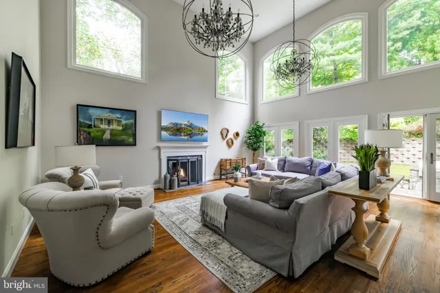 a living room with furniture a fireplace and a large mirror