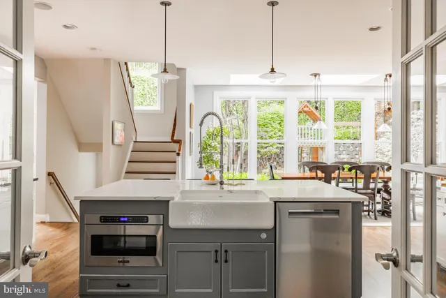 a kitchen with a sink window and cabinets