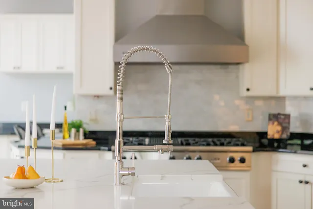 a kitchen with a sink and white cabinets