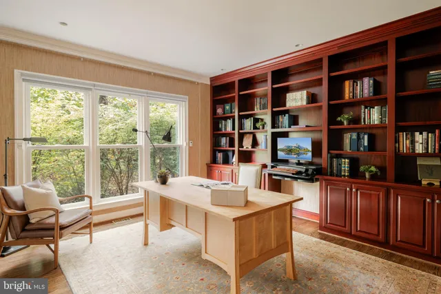 a kitchen with a large window and a view of living room
