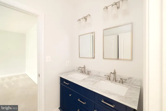 a bathroom with a granite countertop sink a mirror and