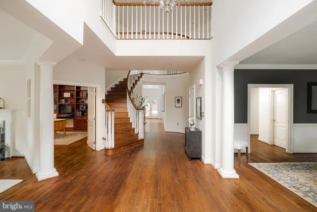 a view of a hallway view with wooden floor and staircase