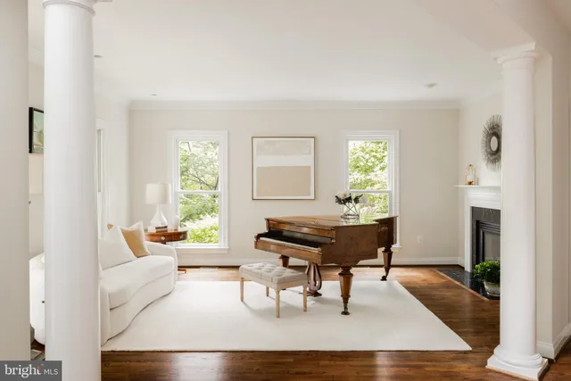 a living room with furniture a fireplace and a table