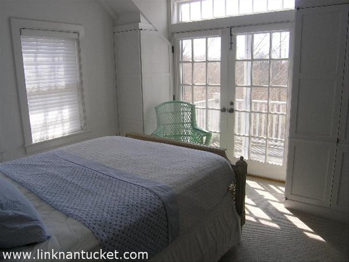 34 R Cliff Road Nantucket, MA 02554 - Photo 10 of 14 a bedroom with a bed and a window