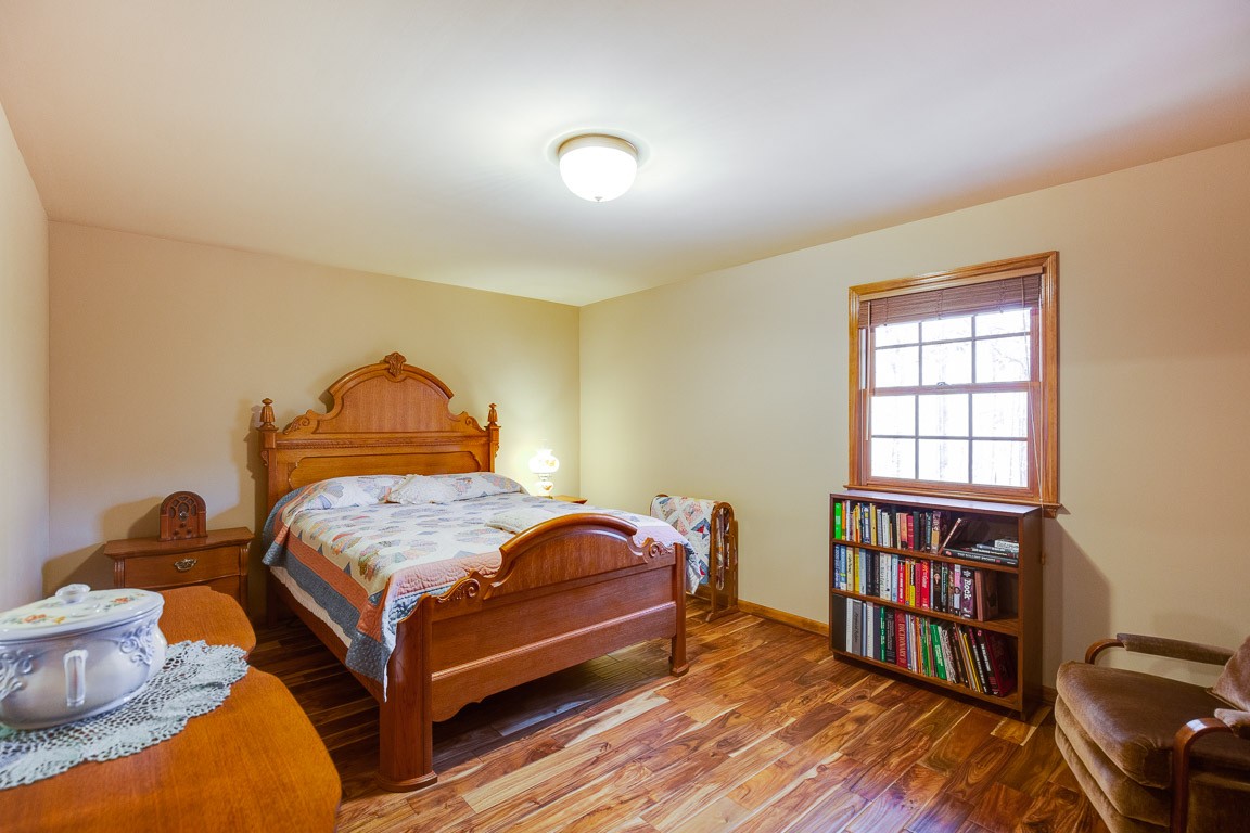 384 South Ray Road Portland, TN 37148 - Photo 22 of 38 a bedroom with a bed and a book shelf