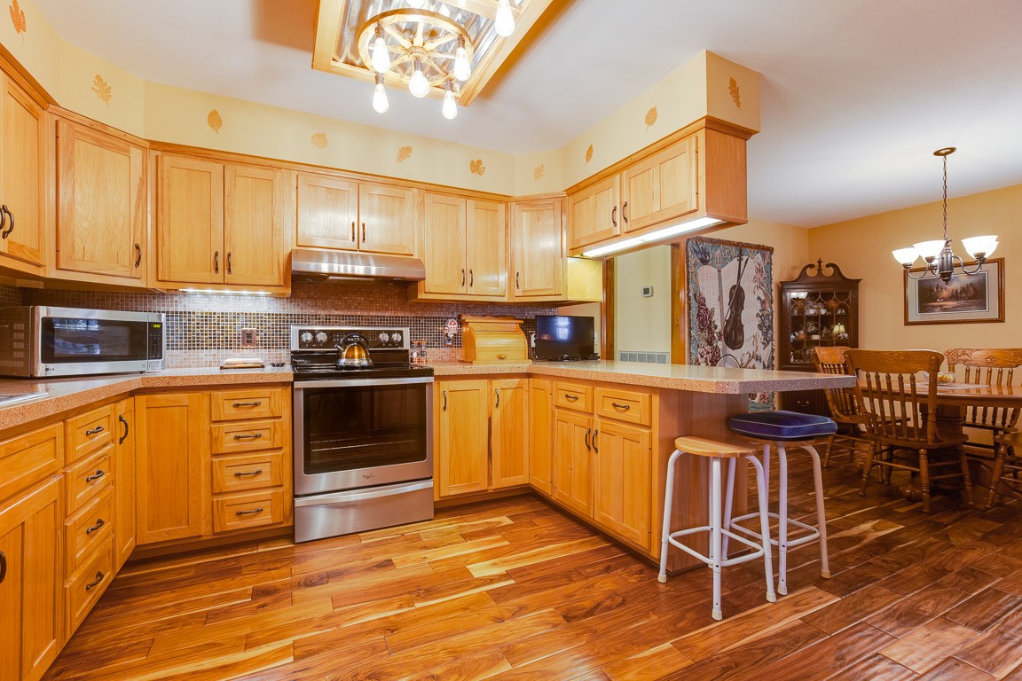 384 South Ray Road Portland, TN 37148 - Photo 8 of 38 a kitchen with stainless steel appliances granite countertop a stove a sink dishwasher and a refrigerator with wooden floor
