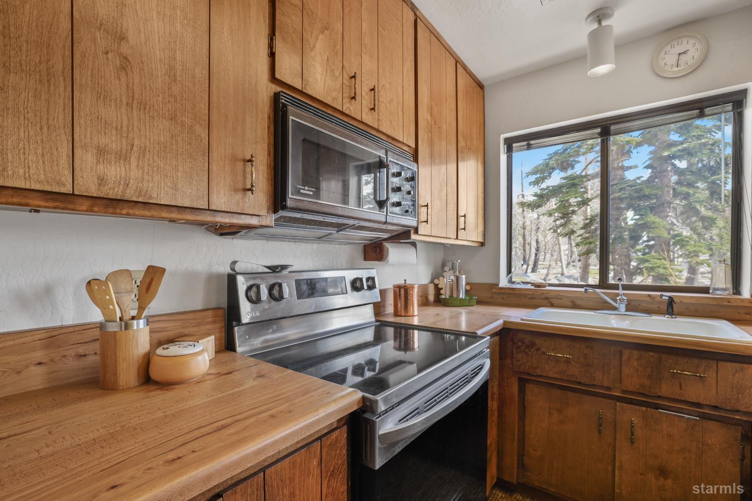2051 Huckleberry Road Twin Bridges, CA 95735 - Photo 18 of 40 a kitchen with a sink and wooden cabinets