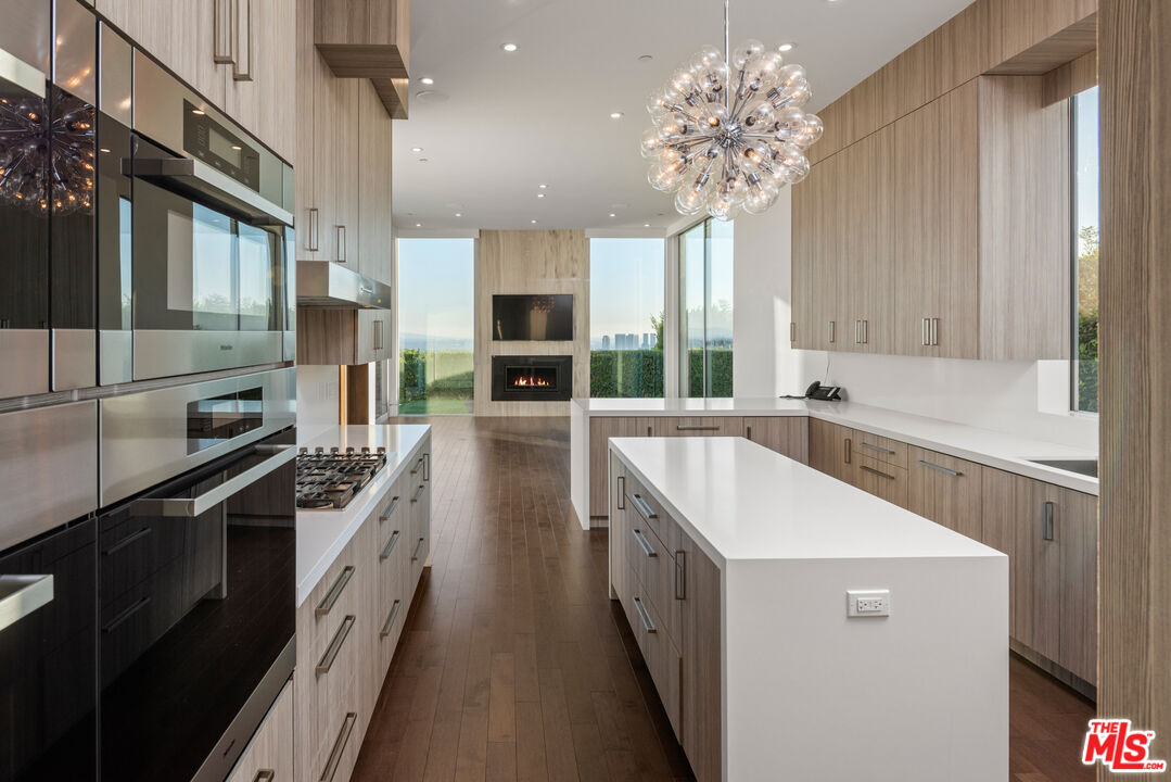 1115 Wallace Ridge Beverly Hills, CA 90210 - Photo 14 of 18 a kitchen with a sink stove and refrigerator