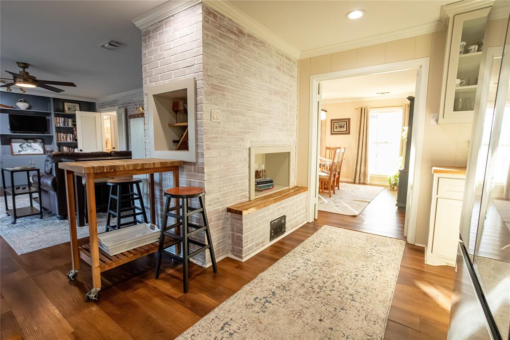909 Cherry Street Baird, TX 79504 - Photo 12 of 32 a spacious bedroom with a bed and wooden floor