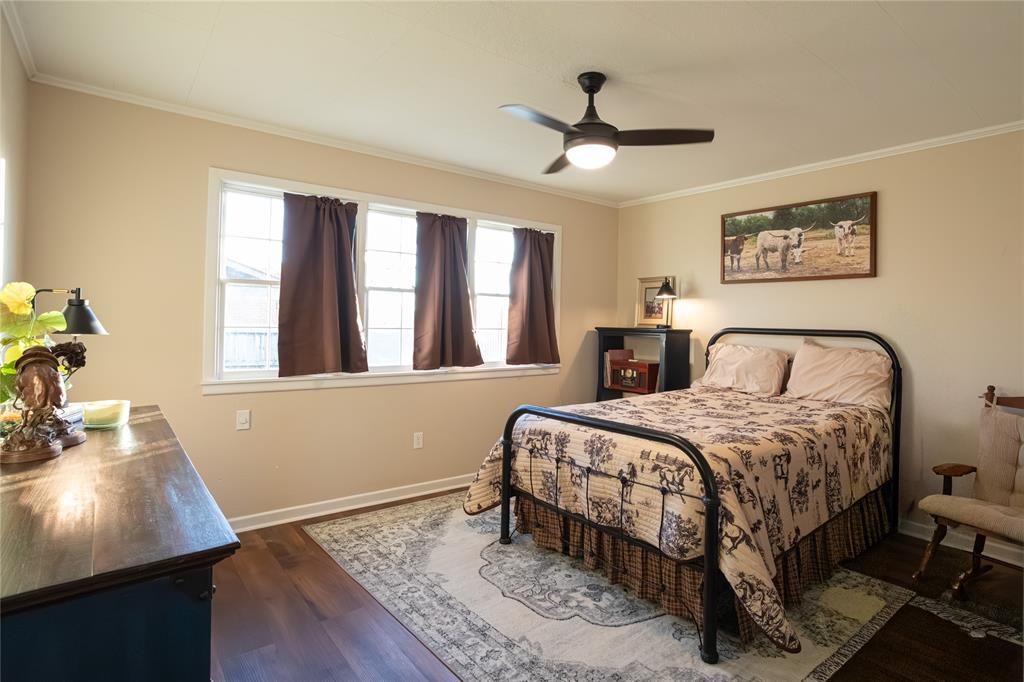 909 Cherry Street Baird, TX 79504 - Photo 22 of 32 a bedroom with a bed and a desk