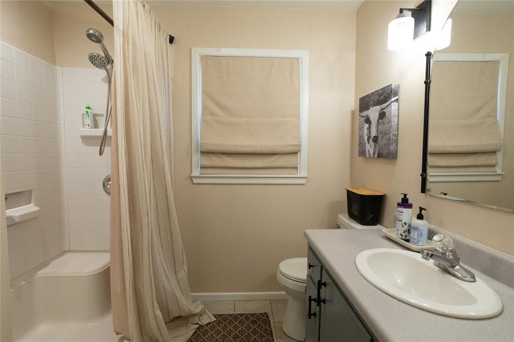 909 Cherry Street Baird, TX 79504 - Photo 24 of 32 a bathroom with a sink toilet and shower