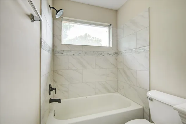 a bath tub sitting next to a white toilet