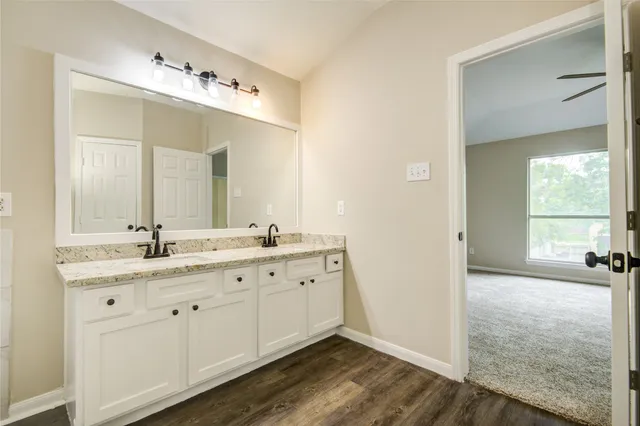 a bathroom with a granite countertop sink mirror and