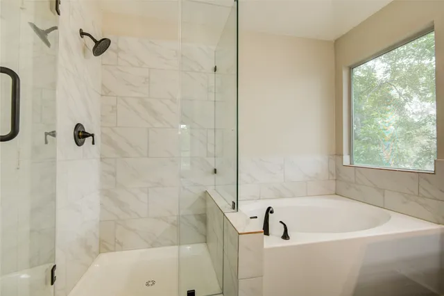 a bathroom with a shower and window