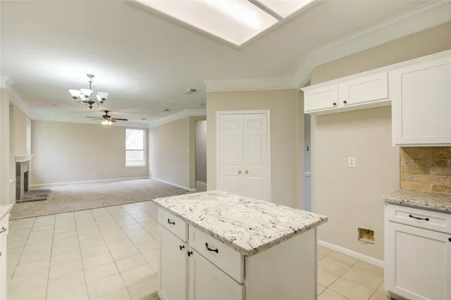 a kitchen with a sink cabinets and chandelier