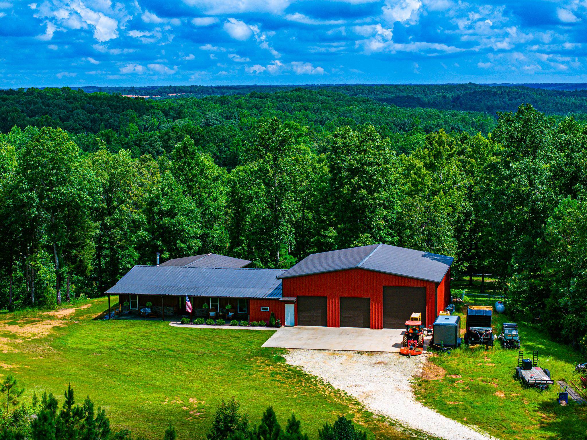 350 Hamilton Road Springville, TN 38256 - Photo 1 of 40 Ranch-style residence featuring a red exterior and a dark metal roof