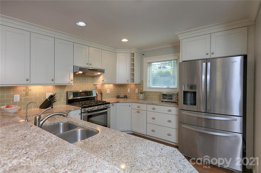 155 Agnew Road Mooresville, NC 28117 - Photo 14 of 37 a kitchen with stainless steel appliances granite countertop a refrigerator sink and white cabinets