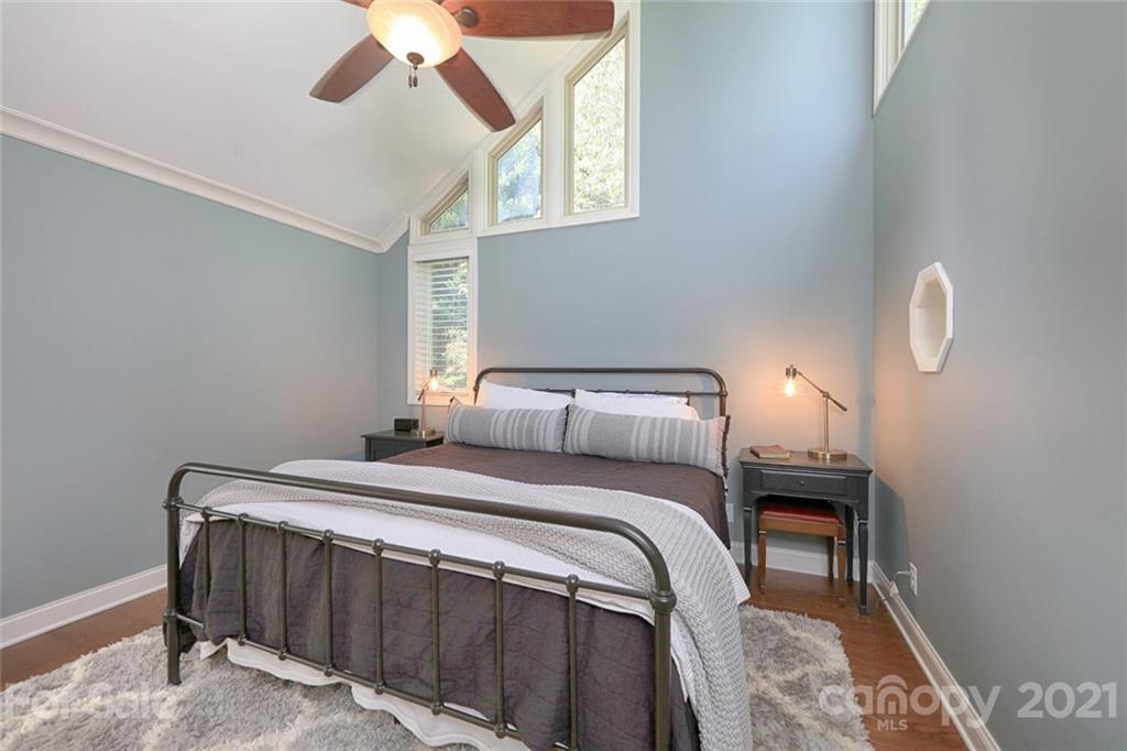 155 Agnew Road Mooresville, NC 28117 - Photo 20 of 37 a bedroom with a bed and a chandelier