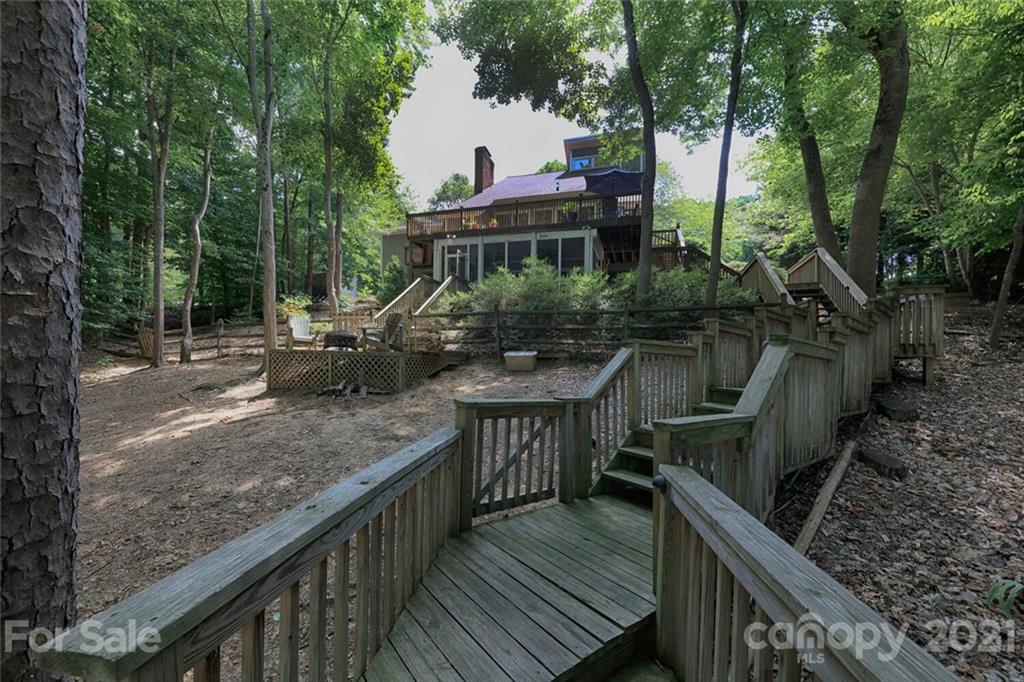 155 Agnew Road Mooresville, NC 28117 - Photo 3 of 37 a view of house with deck outdoor seating and trees