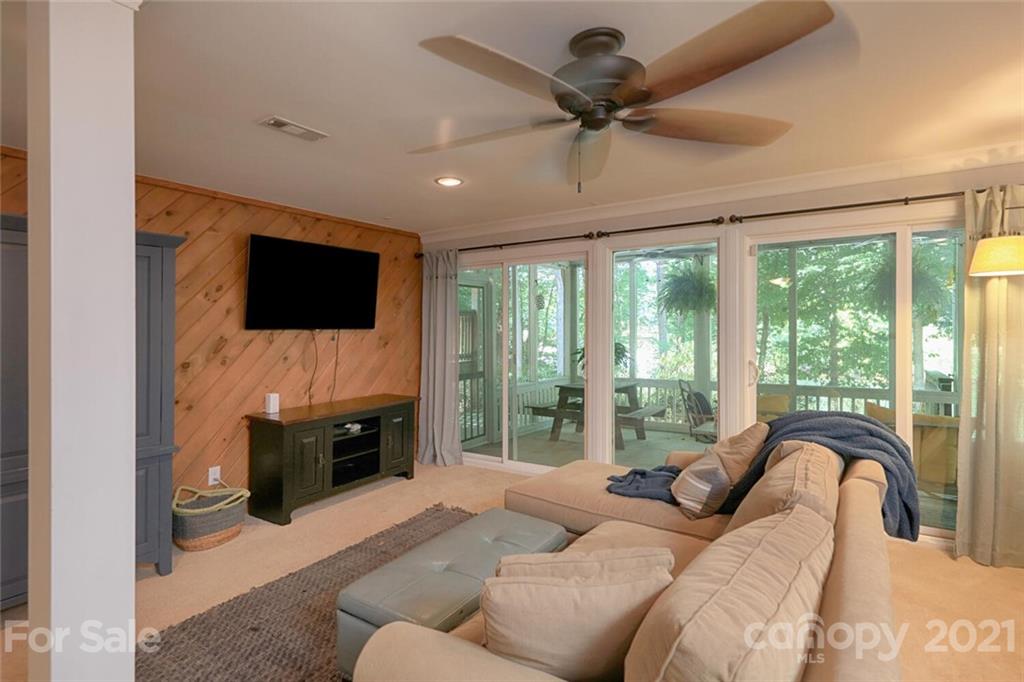 155 Agnew Road Mooresville, NC 28117 - Photo 25 of 37 a living room with furniture a ceiling fan and a flat screen tv