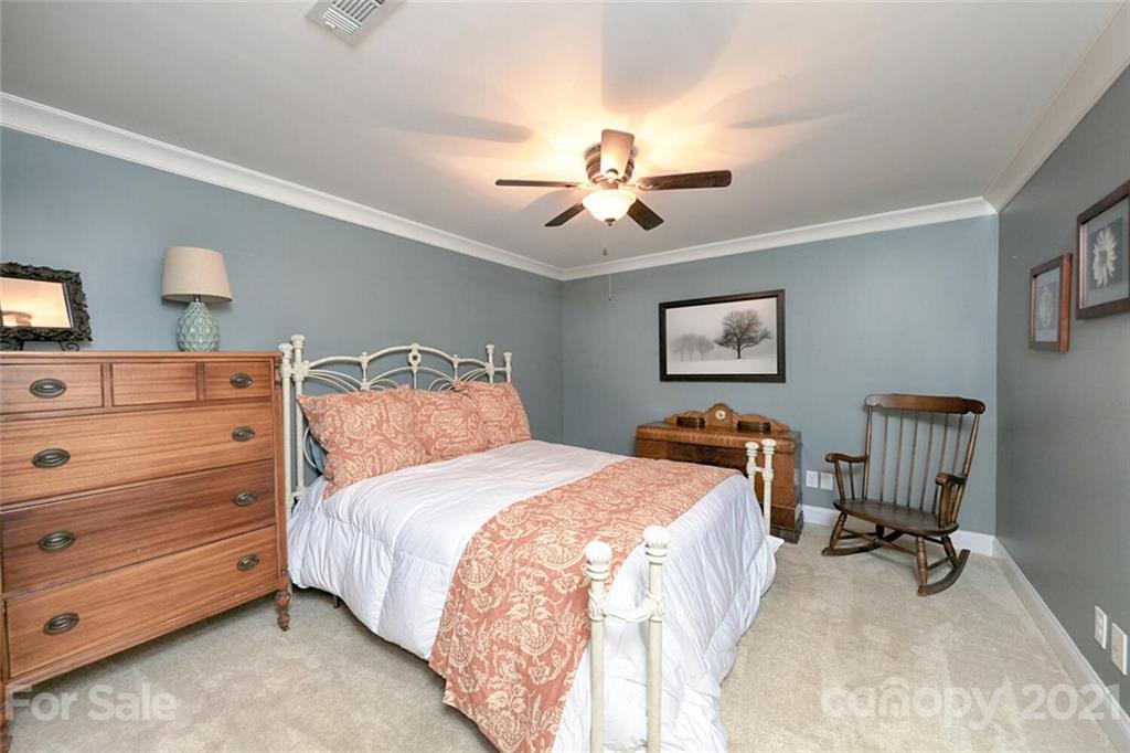 155 Agnew Road Mooresville, NC 28117 - Photo 29 of 37 a bedroom with a bed and a chandelier