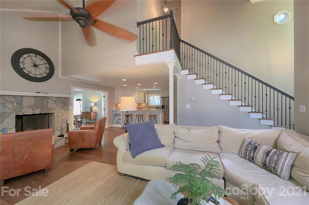155 Agnew Road Mooresville, NC 28117 - Photo 4 of 37 a living room with furniture a clock and a fireplace