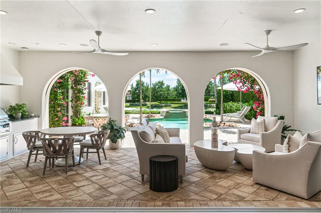 16755 Lucarno Way Naples, FL 34110 - Photo 26 of 50 a living room with patio furniture and a large window