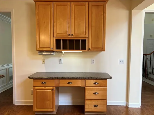 a view of a hallway with wooden floor and stairs
