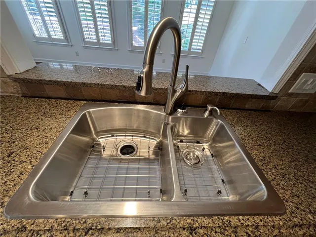 a view of a kitchen with wooden floor and electronic appliances