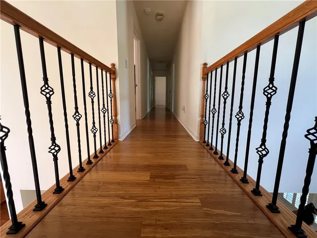 a view of a house with a large window and wooden fence