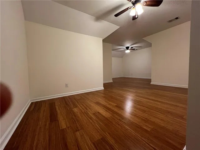 a view of a house with a large window and wooden floor