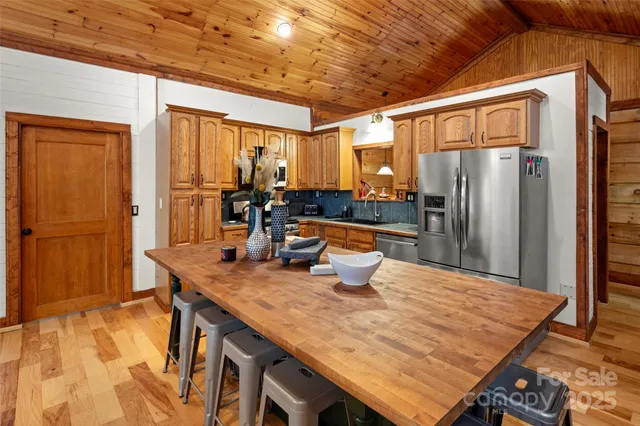 a view of kitchen with sink stove top oven and refrigerator