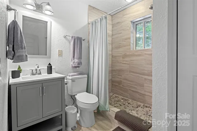 a bedroom with a bed dresser and a window