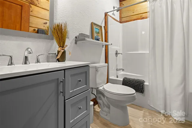 an aerial view of a house with a yard and trees