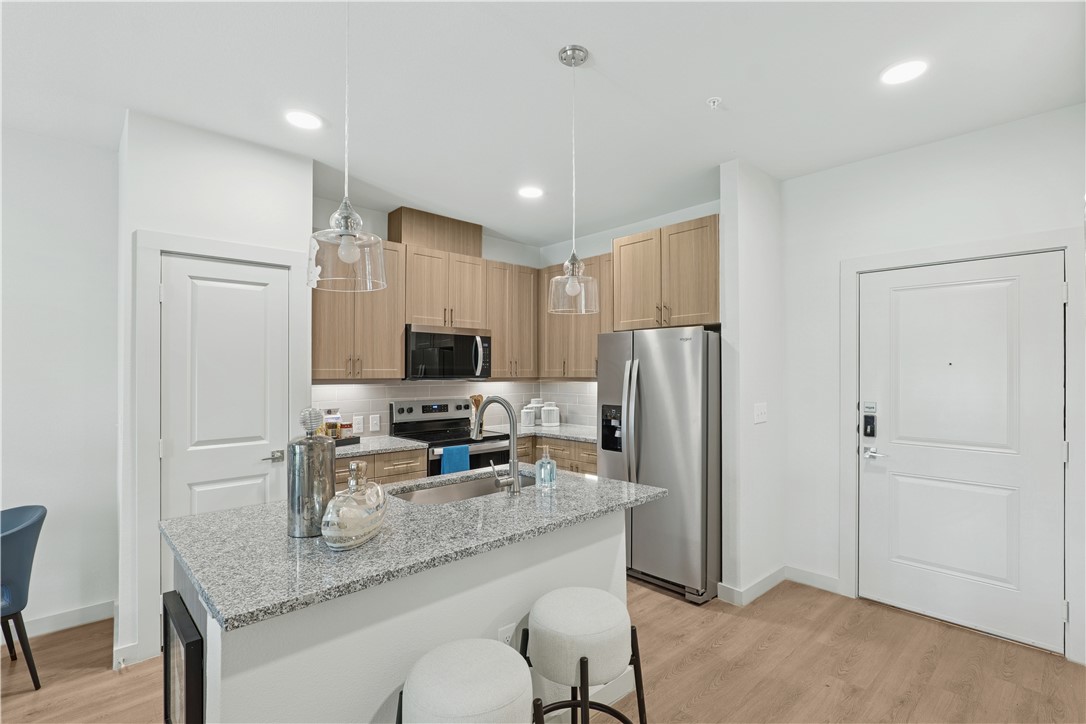 6000 Jones Road, Unit 4414 Bryan, TX 77807 - Photo 10 of 16 a kitchen with stainless steel appliances granite countertop a refrigerator and a sink