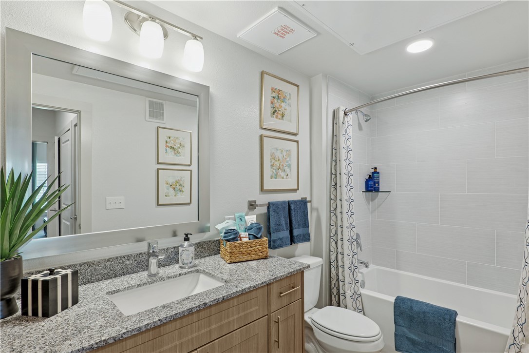6000 Jones Road, Unit 4414 Bryan, TX 77807 - Photo 14 of 16 a bathroom with a granite countertop sink toilet tub and shower