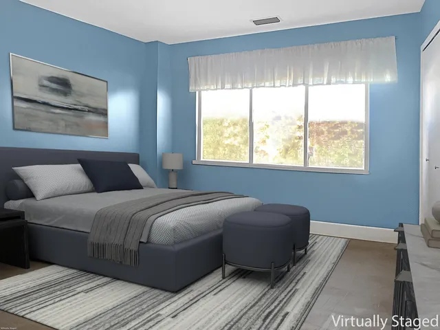 a bedroom with a large bed and a window