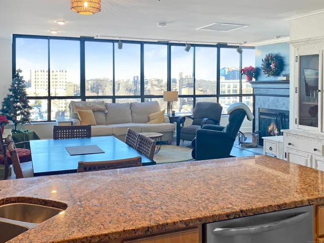 a living room with furniture large window and a table