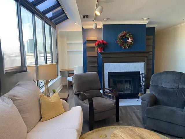 a living room with furniture and a fireplace