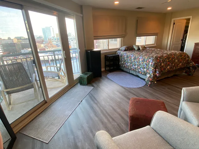 a bedroom with a large bed and a large window