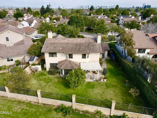 an aerial view of a house with a garden and lake view