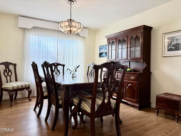 a view of a dining room with furniture and chandelier