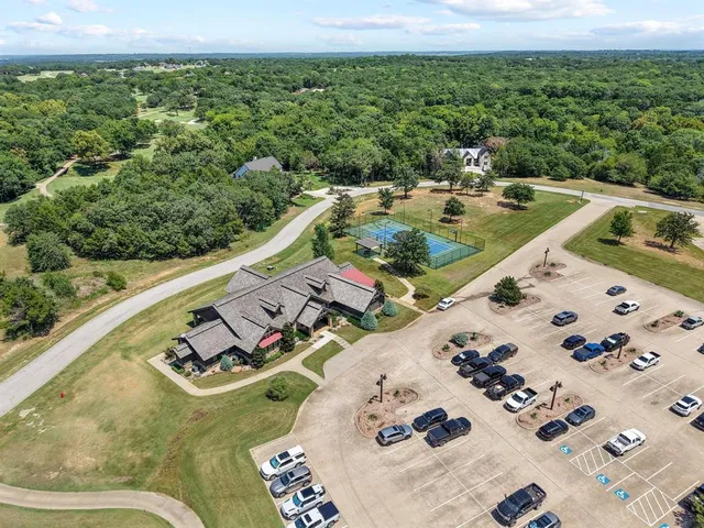an aerial view of a house with swimming pool garden and patio