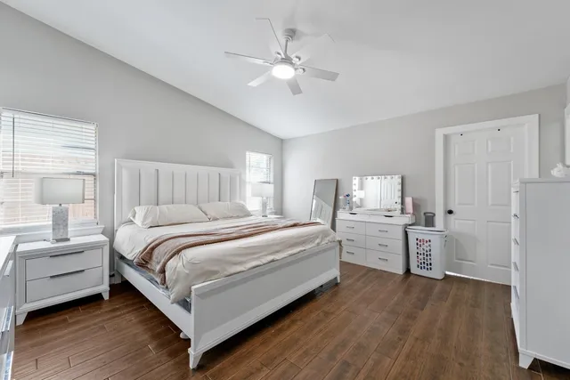 a bedroom with bed and white cabinets