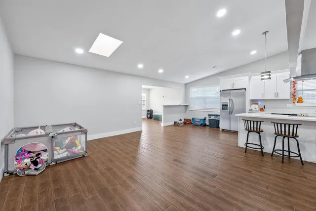 a view of kitchen with furniture and wooden floor