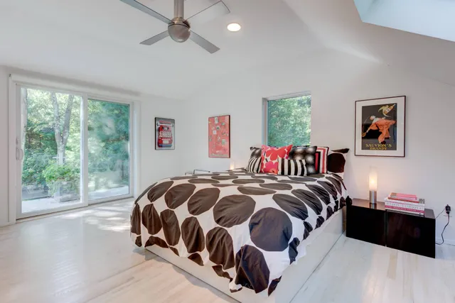 a bedroom with a large bed and a window